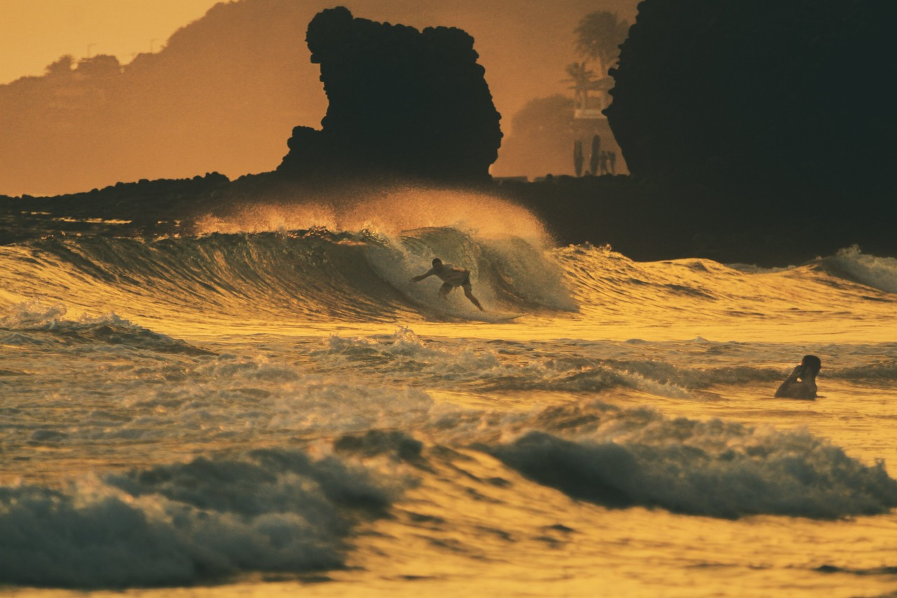 Surfer at sunset on the Pacific coast